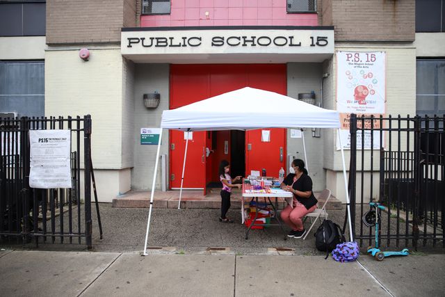 A school in Red Hook with red doors slightly opened